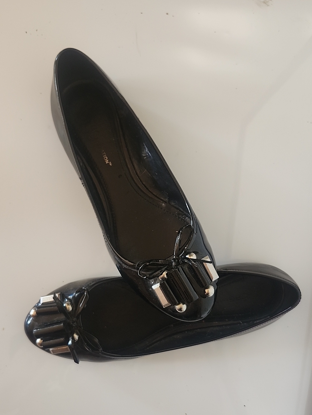 Black Patent Ballet Flats with Decorative Tassel Accent By BCBG